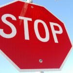 Stop sign image. White text on red octagon reads: STOP