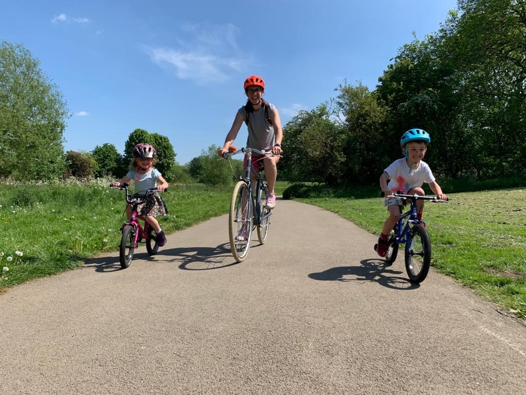 Mother and children cycling image