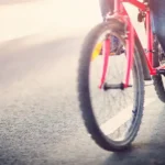 Person cycling on road image