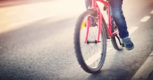 Person cycling on road image