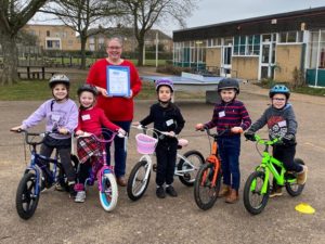 Sarah Byrne received the Silver Certificate surrounded by some of the children who took part in the fun skills cycling session image