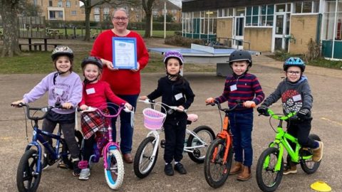 Sarah Byrne received the Silver Certificate surrounded by some of the children who took part in the fun skills cycling session image