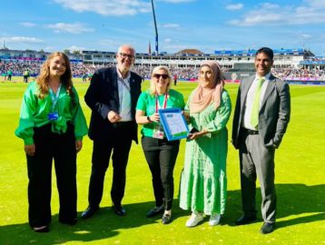 Councillors Majid Mahmood and Mariam Khan present the Sustainability Team at Edgbaston Cricket Stadium with Modeshift STARS Accreditation certificate pitch side