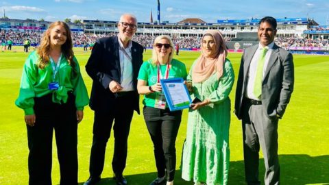 Councillors Majid Mahmood and Mariam Khan present the Sustainability Team at Edgbaston Cricket Stadium with Modeshift STARS Accreditation certificate pitch side