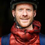 Ed Clancy OBE in cycling helmet smiles at camera