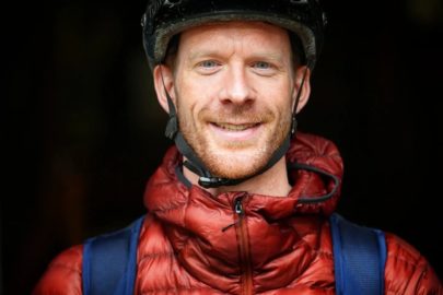 Ed Clancy OBE in cycling helmet smiles at camera