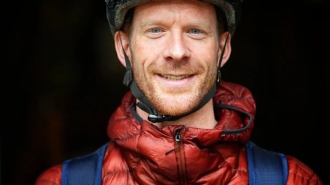 Ed Clancy OBE in cycling helmet smiles at camera