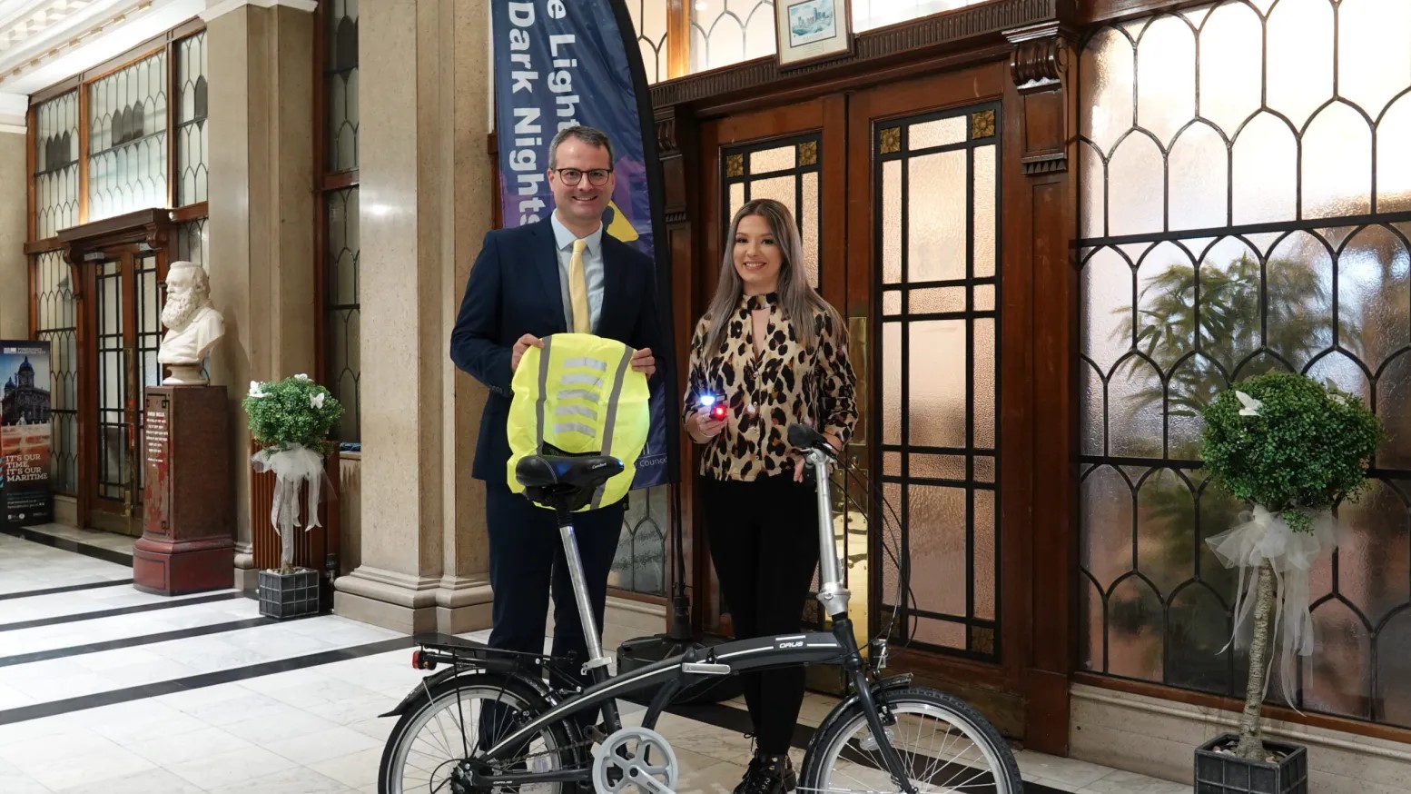 Pictured in the image: Caitlynne Picott Travel  Plan Officer, Hull City Council & Councillor Mark Ieronimo, cabinet portfolio holder for transportation, roads and highways. Stand with bike holding High Viz Vest and lights.