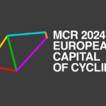 MCR 2024 European Capital of Cycling logo image. White text on grey background with multi-coloured prism shape