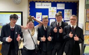 Five Applefields Students pose with thumbs up