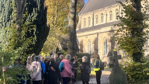 Group of people in a church yard. Patients enjoying the trail and learning about St Mark’s Church, designed by Sir George Gilbert Scott (architect of St Pancras Station)