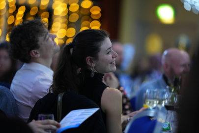 Modeshift 2023 Sustainable Travel Awards - crowd seated at tables, twinkling lights in background, applauding winners