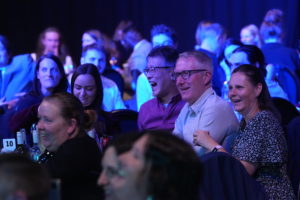 Audience at the National Sustainable Travel Awards, clapping and smiling looking towards the stage.