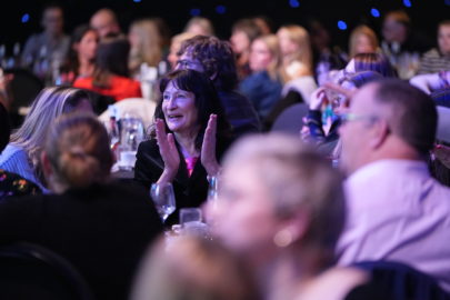 Audience at the National Sustainable Travel Awards, clapping and smiling looking towards the stage.