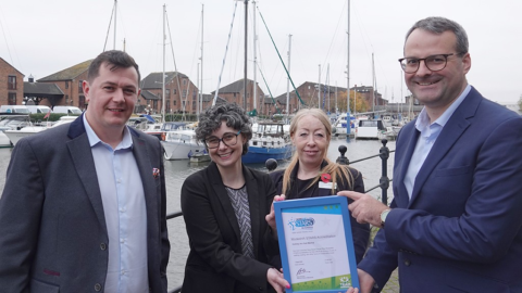 Credit: Business Works. Four people stand together. Two women in the centre hold a Modeshift STARS certificate.