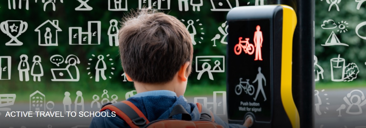 Child with backpack pressing pedestrian crossing button showing red bicycle and walking figure signals.