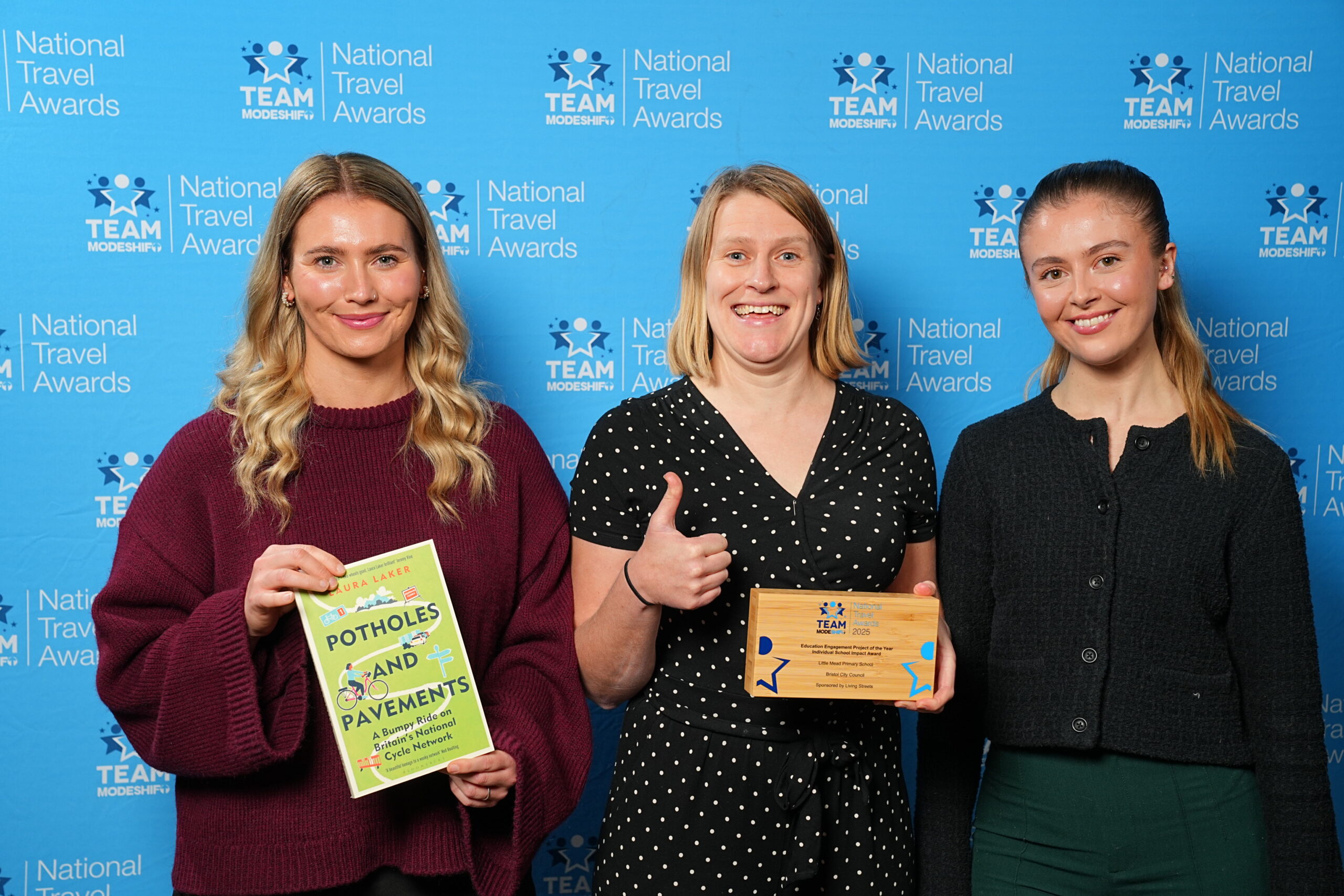 Education Engagement Project of the Year – Individual School Impact Award Sponsored by Living Streets Little Mead Primary School Bristol City Council Group of people stand smiling, central figures holding their TeamModeshift Award