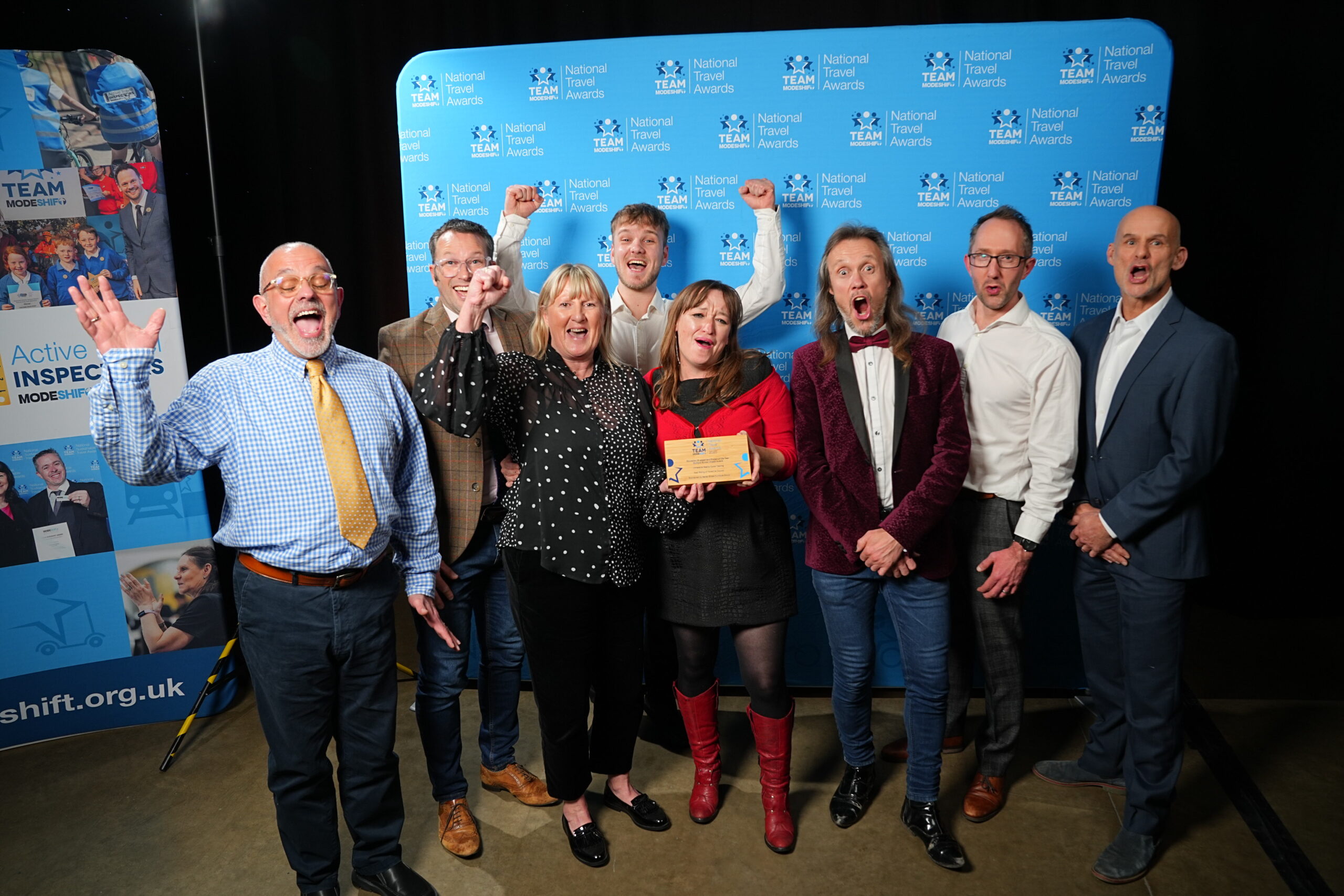 Education Engagement Project of the Year – Multiple School Impact Award Sponsored by Bailey Street Furniture Group Immersive Reality Cycle Training East Riding of Yorkshire Council Group of people stand smiling, central figures holding their TeamModeshift Award