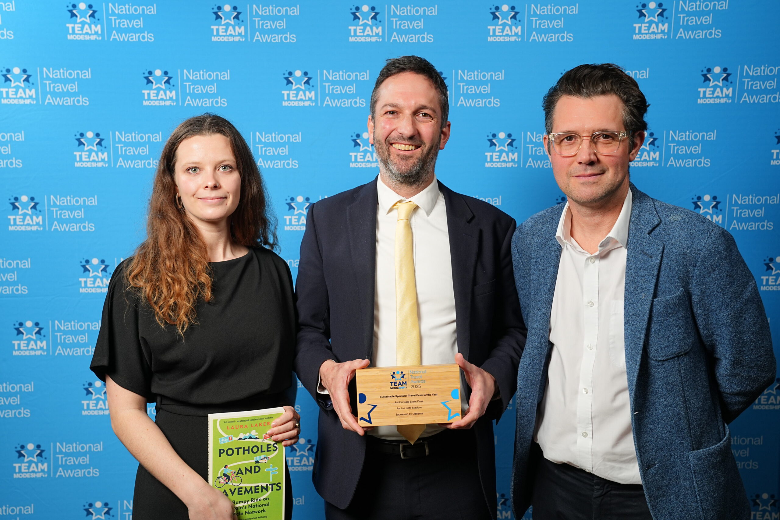 Sustainable Spectator Travel Event of the Year Sponsored by Citisense Ashton Gate Event Days Ashton Gate Stadium Group of people stand smiling, central figures holding their TeamModeshift Award