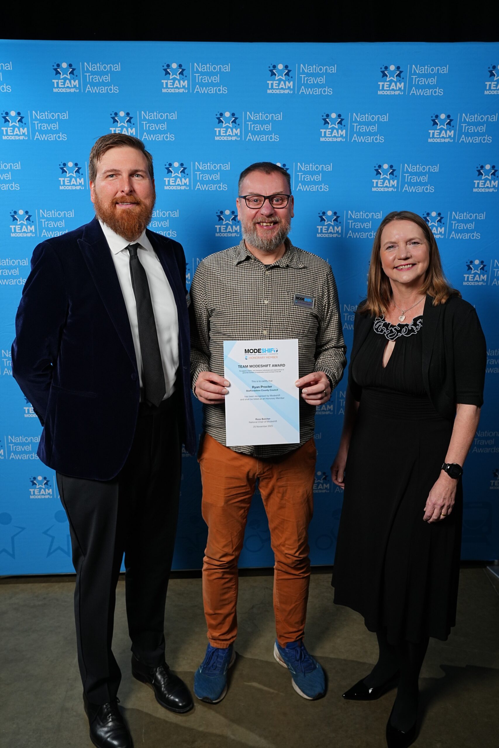 Ryan Procter, Staffordshire County Council poses with Honorary Member Certificate, two people smile at camera either side.