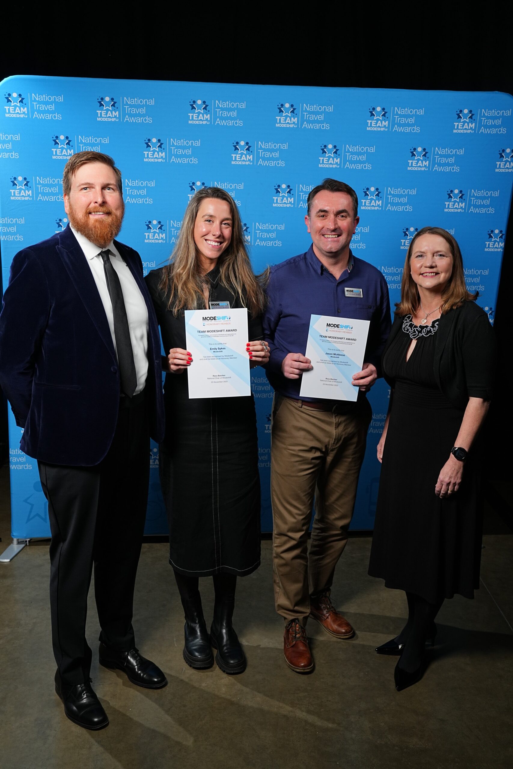 Jason McAleese, Modeshift and Emily Sykes pose with Honorary Member Certificates, two people smile at camera either side.