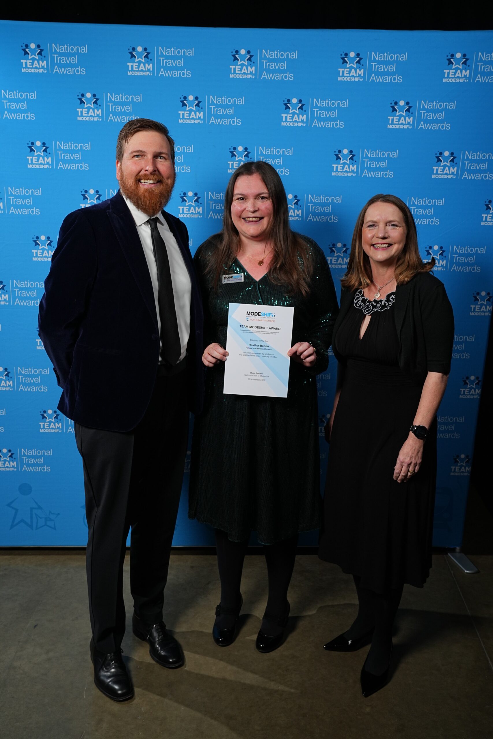 Heather Bolton, Telford and Wrekin Council poses with Honorary Member Certificate, two people smile at camera either side.