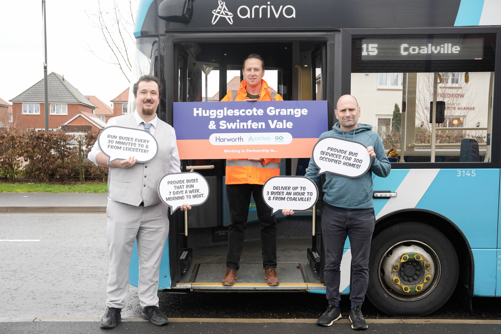 Three men stand in front of an Arriva bus holding signs promoting Hugglescote Grange & Swinfen Vale with Harworth and Bircotes stops.