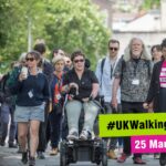 Group of diverse people walking outdoors. Text reads: #UKWalkingSummit 25 March 2026.