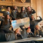 Students in school uniform pose with a large cheque for the Active Travel Ambassadors Campaign funding awarded at the Campaign Junction event.