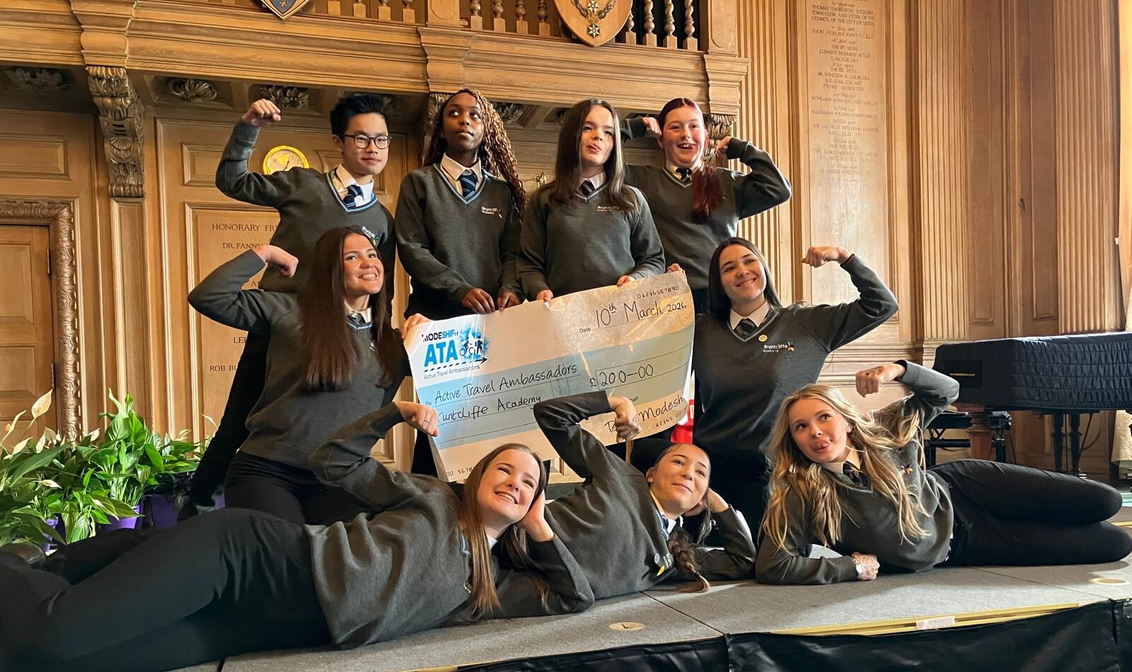 Students in school uniform pose with a large cheque for the Active Travel Ambassadors Campaign funding awarded at the Campaign Junction event.